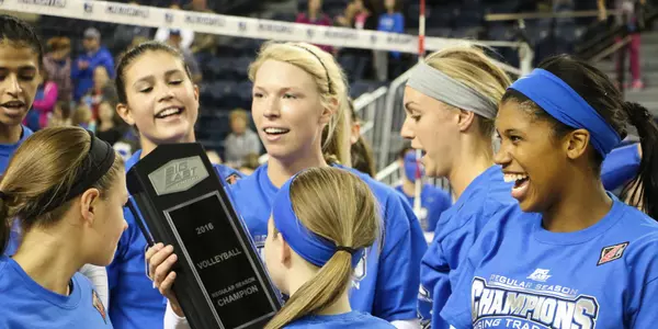 Lauren Smith holds the 2016 BIG EAST trophy