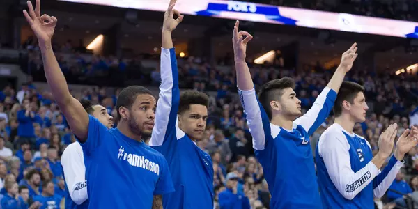 Maurice Watson Jr. and bench celebrate