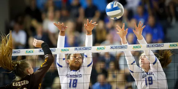 Madelyn Cole and Megan Ballenger block