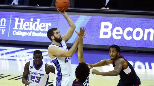 Jan 23, 2021; Omaha, Nebraska, USA;  Creighton Bluejays guard Mitch Ballock (24) scores over Connecticut Huskies guard Jalen Gaffney (0) in the second half at CHI Health Center Omaha. Mandatory Credit: Steven Branscombe-USA TODAY Sports