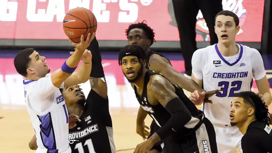 Jan 20, 2021; Omaha, Nebraska, USA;  Creighton Bluejays guard Marcus Zegarowski (11) shoots over Providence Friars guard A.J. Reeves (11) in the first half at CHI Health Center Omaha. Mandatory Credit: Steven Branscombe-USA TODAY Sports