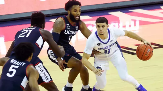 Jan 23, 2021; Omaha, Nebraska, USA;  Creighton Bluejays guard Marcus Zegarowski (11) dribbles against Connecticut Huskies guard R.J. Cole (1) and forward Adama Sanogo (21) in the first half at CHI Health Center Omaha. Mandatory Credit: Steven Branscombe-USA TODAY Sports