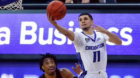 Jan 23, 2021; Omaha, Nebraska, USA;  Creighton Bluejays guard Marcus Zegarowski (11) scores against Connecticut Huskies forward Isaiah Whaley (5) in the second half at CHI Health Center Omaha. Mandatory Credit: Steven Branscombe-USA TODAY Sports
