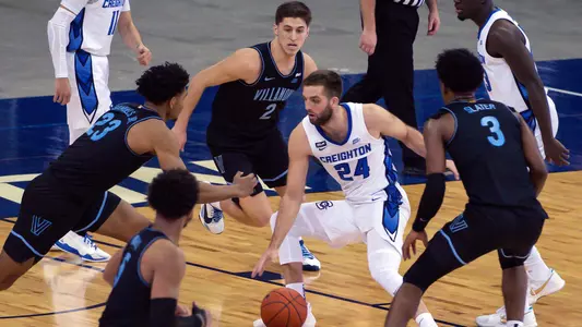 Feb 13, 2021; Omaha, Nebraska, USA;  Creighton Bluejays guard Mitch Ballock (24) dribbles between Villanova Wildcats forward Jermaine Samuels (23) and guard Collin Gillespie (2) and forward Brandon Slater (3) in the second half at CHI Health Center Omaha. Mandatory Credit: Steven Branscombe-USA TODAY Sports