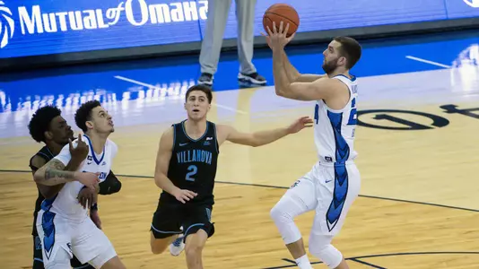 Feb 13, 2021; Omaha, Nebraska, USA;  Creighton Bluejays guard Mitch Ballock (24) shoots against Villanova Wildcats guard Collin Gillespie (2) in the second half at CHI Health Center Omaha. Mandatory Credit: Steven Branscombe-USA TODAY Sports