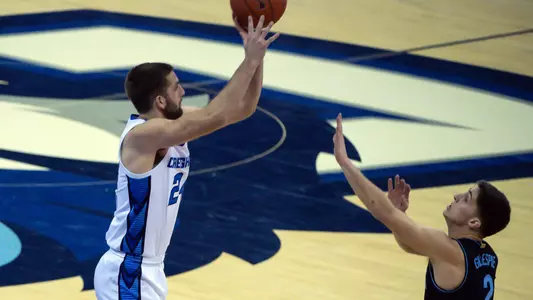Feb 13, 2021; Omaha, Nebraska, USA;  Creighton Bluejays guard Mitch Ballock (24) attempts a three point shot over Villanova Wildcats guard Collin Gillespie (2) in the second half at CHI Health Center Omaha. Mandatory Credit: Steven Branscombe-USA TODAY Sports