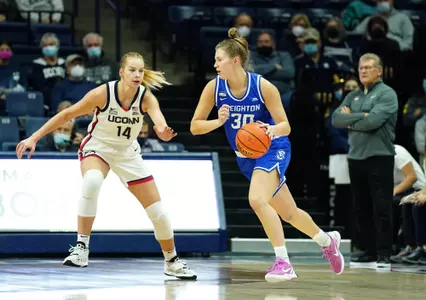 Jan 9, 2022; Storrs, Connecticut, USA; Creighton Bluejays guard Morgan Maly (30) drives the ball against UConn Huskies forward Dorka Juhasz (14) in the first half at Harry A. Gampel Pavilion. Mandatory Credit: David Butler II-USA TODAY Sports