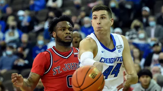 Jan 19, 2022; Omaha, Nebraska, USA;  Creighton Bluejays forward Ryan Hawkins (44) passes against St. John's Red Storm guard Posh Alexander (0) in the first half at CHI Health Center Omaha. Mandatory Credit: Steven Branscombe-USA TODAY Sports