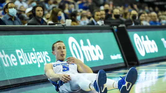 Jan 19, 2022; Omaha, Nebraska, USA;  Creighton Bluejays guard Alex O'Connell (5) is knocked down after hitting a three point basket against the St. John's Red Storm in the first half at CHI Health Center Omaha. Mandatory Credit: Steven Branscombe-USA TODAY Sports