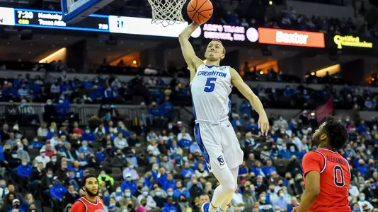 Jan 19, 2022; Omaha, Nebraska, USA;  Creighton Bluejays guard Alex O'Connell (5) dunks against St. John's Red Storm guard Posh Alexander (0) in the second half at CHI Health Center Omaha. Mandatory Credit: Steven Branscombe-USA TODAY Sports