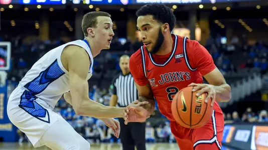 Jan 19, 2022; Omaha, Nebraska, USA;  St. John's Red Storm guard Julian Champagnie (2) drives against Creighton Bluejays guard Alex O'Connell (5) in the first half at CHI Health Center Omaha. Mandatory Credit: Steven Branscombe-USA TODAY Sports