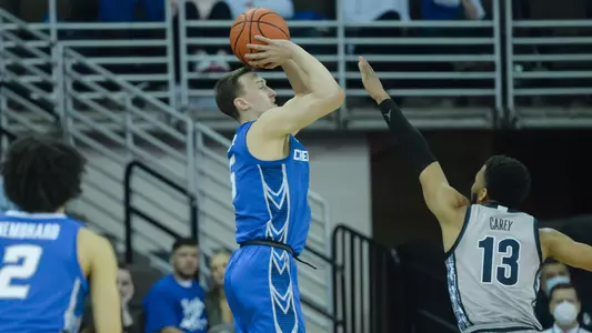 Feb 14, 2022; Omaha, Nebraska, USA;  Creighton Bluejays guard Alex O'Connell (5) attempts a three point shot against Georgetown Hoyas guard Donald Carey (13) in the first half at CHI Health Center Omaha. Mandatory Credit: Steven Branscombe-USA TODAY Sports