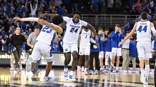 Mar 2, 2022; Omaha, Nebraska, USA;  Creighton Bluejays guard Trey Alexander (23) and forward Arthur Kaluma (24) celebrate the win against the Connecticut Huskies at CHI Health Center Omaha. Mandatory Credit: Steven Branscombe-USA TODAY Sports
