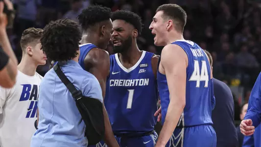 Mar 11, 2022; New York, NY, USA;  Creighton Bluejays forward Arthur Kaluma (24) is greeted by forwards KeyShawn Feazell (1) and Ryan Hawkins (44) after scoring and being fouled in the second half against the Providence Friars at the Big East Tournament at Madison Square Garden. Mandatory Credit: Wendell Cruz-USA TODAY Sports