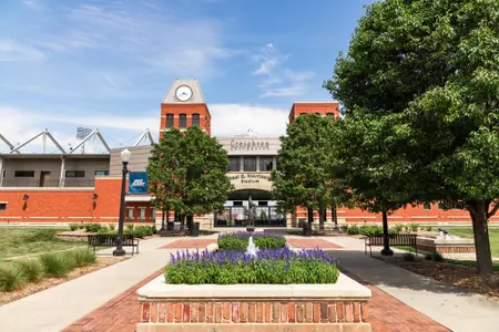 Morrison Stadium with the fountains, statue, and flowers in front from straighten on 2022