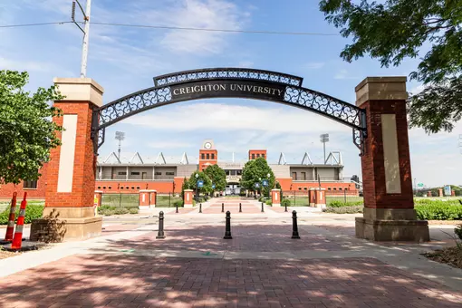 Morrison Stadium from campus with university arch 2022