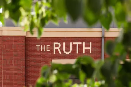 The Ruth Training Center name plate through the trees 2022