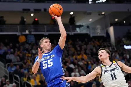 Dec 30, 2023; Milwaukee, Wisconsin, USA; Creighton Bluejays guard Baylor Scheierman (55) shoots over Marquette Golden Eagles guard Tyler Kolek (11) during the first half at Fiserv Forum. Mandatory Credit: Jeff Hanisch-USA TODAY Sports