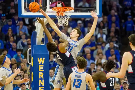 Feb 11, 2023; Omaha, Nebraska, USA; Creighton Bluejays center Ryan Kalkbrenner (11) blocks a shot by Connecticut Huskies guard Nahiem Alleyne (4) during the first half at CHI Health Center Omaha. Mandatory Credit: Dylan Widger-USA TODAY Sports