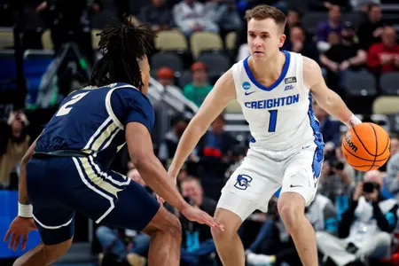 Mar 21, 2024; Pittsburgh, PA, USA; Creighton Bluejays guard Steven Ashworth (1) handles the ball against Akron Zips guard Greg Tribble (2) during the first half in the first round of the 2024 NCAA Tournament at PPG Paints Arena. Mandatory Credit: Charles LeClaire-USA TODAY Sports
