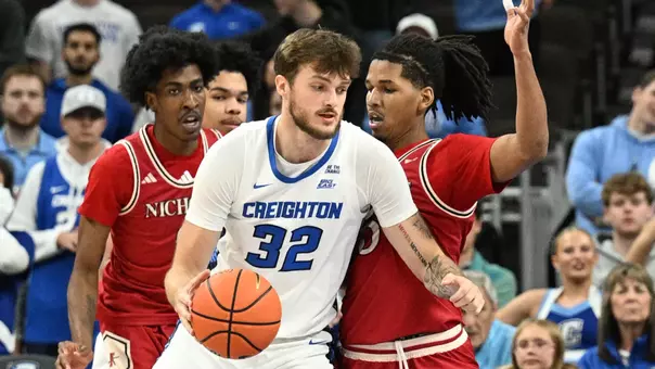 Dec 2, 2025; Omaha, Nebraska, USA; Creighton Bluejays forward Owen Freeman (32) dribbles against Nicholls State Colonels guard Zaiden Cross (9) and forward Sincere Malone (5) during the first half at CHI Health Center Omaha. Mandatory Credit: Steven Branscombe-Imagn Images