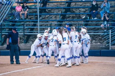 Sydra Seville is mobbed after hitting a grand slam