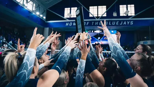 Creighton Volleyball celebrates its 2024 BIG EAST regular-season title with the trophy