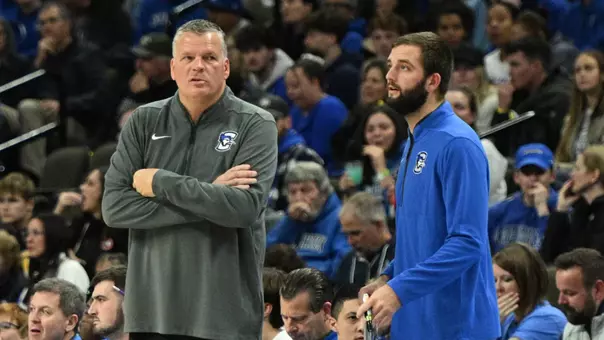 Nov 13, 2024; Omaha, Nebraska, USA; Creighton Bluejays head coach Greg McDermott and assistant coach Mitch Ballock watch action against the Houston Christian Huskies during the first half at CHI Health Center Omaha. Mandatory Credit: Steven Branscombe-Imagn Images