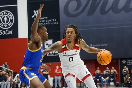 Cal State Northridge Matadors guard Dionte Bostick #0 drives against UC Riverside Highlanders guard Barrington Hargress #24 during an NCCA basketball game at Premier America Credit Union Arena on California State University, Northridge  in Los Angeles, California, Saturday, February 3, 2024. (Ringo Chiu / CSUN)