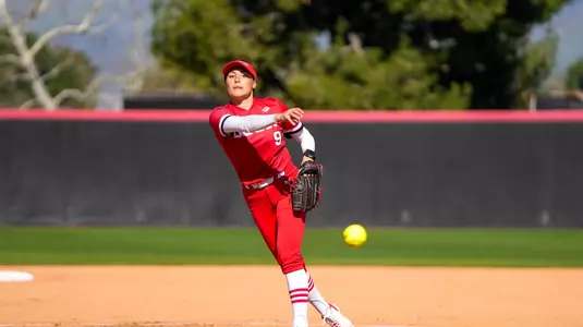 Isabella Alonso pitching the ball.