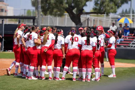 The team standing together with the coach.