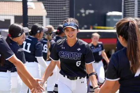 Lulu Sanchez running through the line as her name is announced to be a starter.
