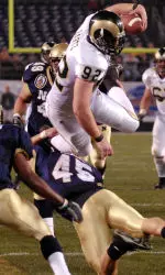 Matt Bartz is upended by Navy's Tyler Tidwell after a 5-yard pass reception in the first quarter.