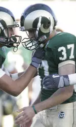 Jason Smith (37) is congratulated by Kevin McPeak after Smith kicked a field goal against New Mexico during the second quarter. (AP Photo/Jack Dempsey)