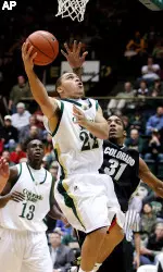 Jesse Woodard lays the ball in as Colorado's Jermyl Jackson defends during the first half.