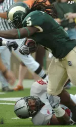 Colorado State ball carrier Gartrell Johnson III rushes past UNLV defender Daryl Forte. (AP Photo/The Fort Collins Coloradoan, Rich Abrahamson)