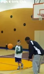 Laurenzio Hernandez, with basketball, goes one-on-one with CSU cornerback Marcus Shaw, one of the player leaders in the first annual CSU community service initiative, March 11 at the Fort Collins Boys & Girls Club