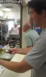 Michael Kawulok serves lunch to the homeless at the Open Door Mission in Old Town Fort Collins Monday afternoon