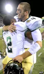 Pete Thomas (4) celebrates with Ezra Thompson after Colorado State defeated Utah State.