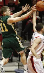 Colorado State guard Jesse Carr passes over San Diego State's James Rahon.