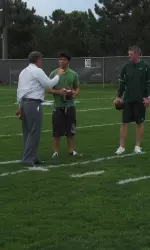 Jim McElwain and Billy Napier offer instruction to CSU student Kirk Bakalis before his big competition.