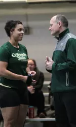 Head coach Brian Bedard talking with thrower Monet Jackson