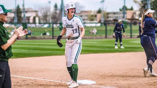Hailey Smith celebrates on third base