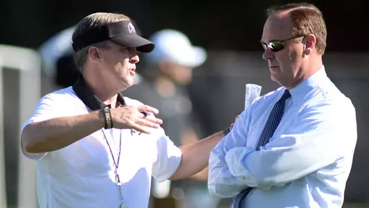 Mike MacIntyre and Rick George