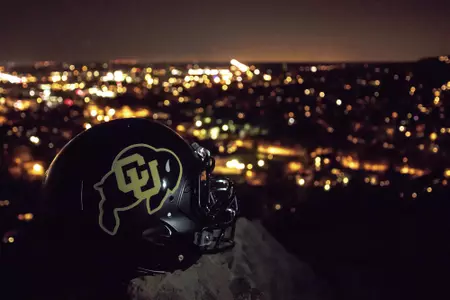 cu football helmet boulder at night