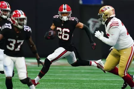Atlanta Falcons cornerback Isaiah Oliver (26) runs the ball after intercepting a pass during an NFL football game against the San Francisco 49ers Sunday, Oct. 16, 2022, in Atlanta. (AP Photo/John Bazemore)