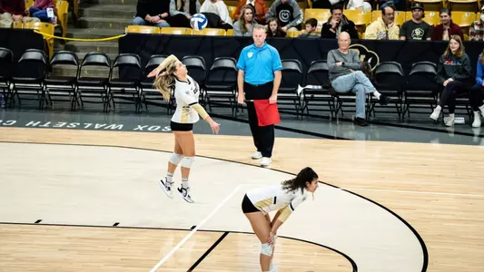 Perry serves against an opponent at the CU Events Center.