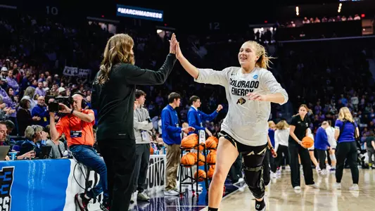 Head coach JR Payne high-five's Maddie Nolan