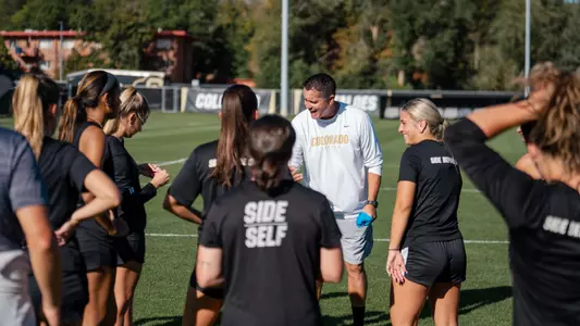 Coach Sanchez in team huddle