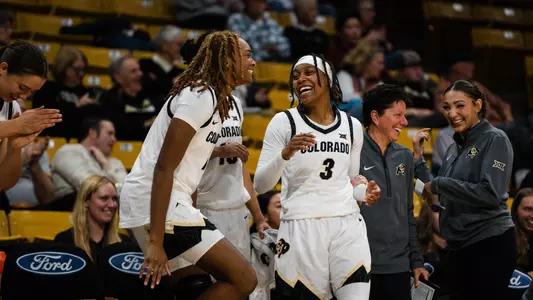 Jade Masogayo and Desiree Wooten on the bench